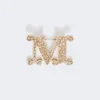 Broszka z monogramem ozdobiona kryształkami, optyczna biel Broszka z monogramem ozdobiona kryształkami, optyczna biel